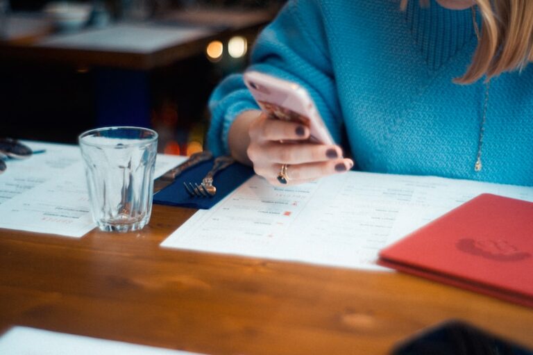 Small business owner reviewing customs and shipping paperwork at a desk