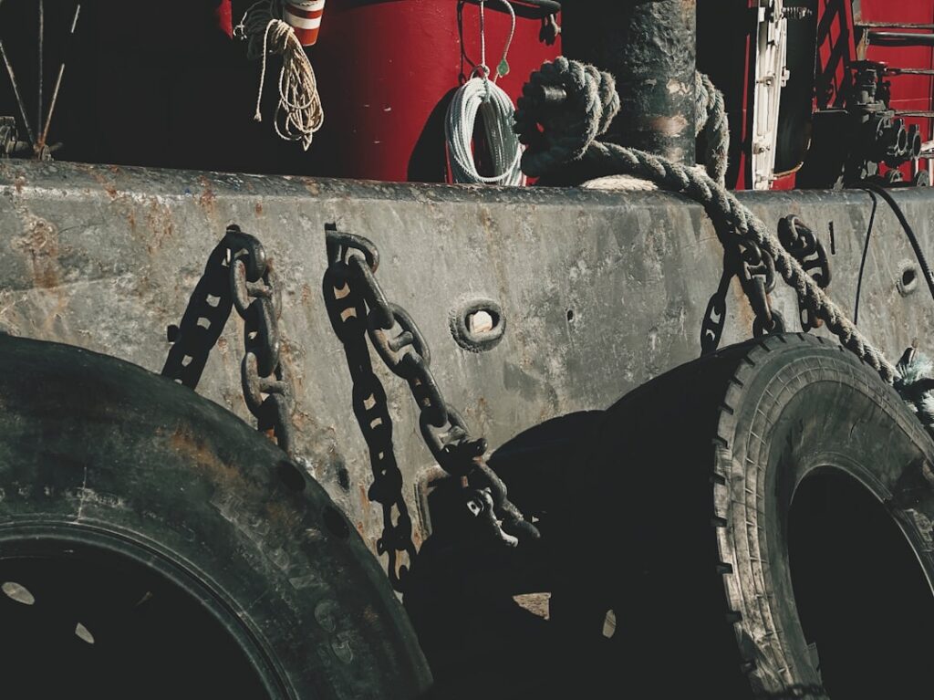 Close-up of a flatbed tow truck's hydraulic lift and chains
