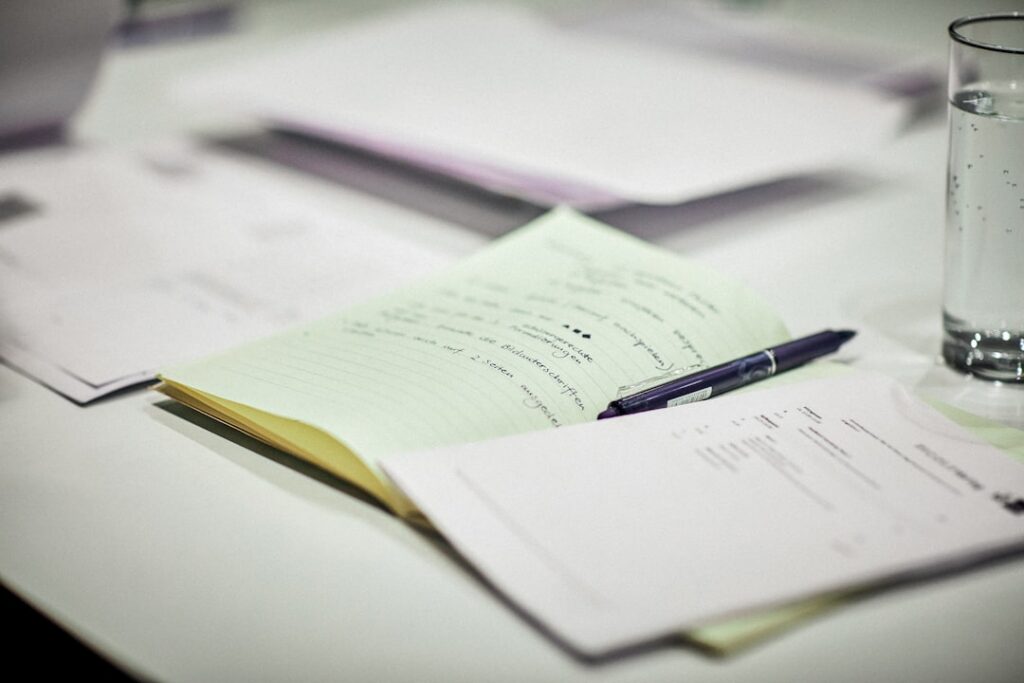 Multiple advance statements stacked on a small business owner's desk