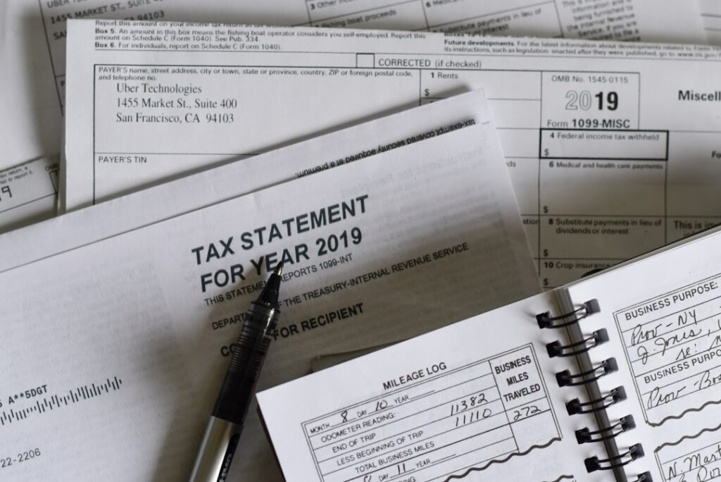 Bank account statement showing daily debits next to a tax form