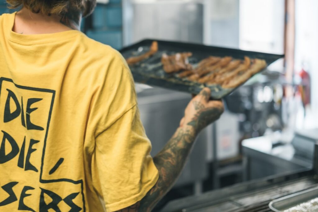 Catering business owner reviewing event bookings and invoices in a commercial kitchen