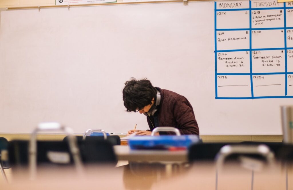 Tutoring center owner reviewing paperwork at an empty desk before the school year starts