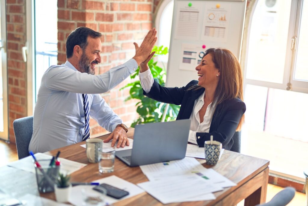 Two people shaking hands after reaching a negotiated settlement agreement