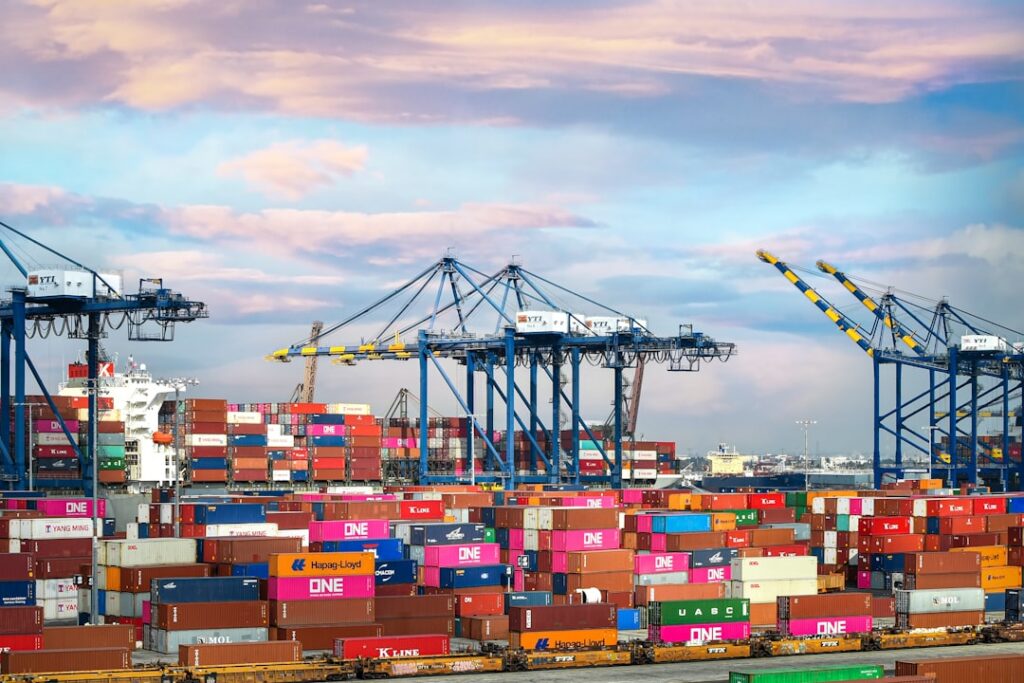 Shipping containers at a port with customs paperwork in the foreground