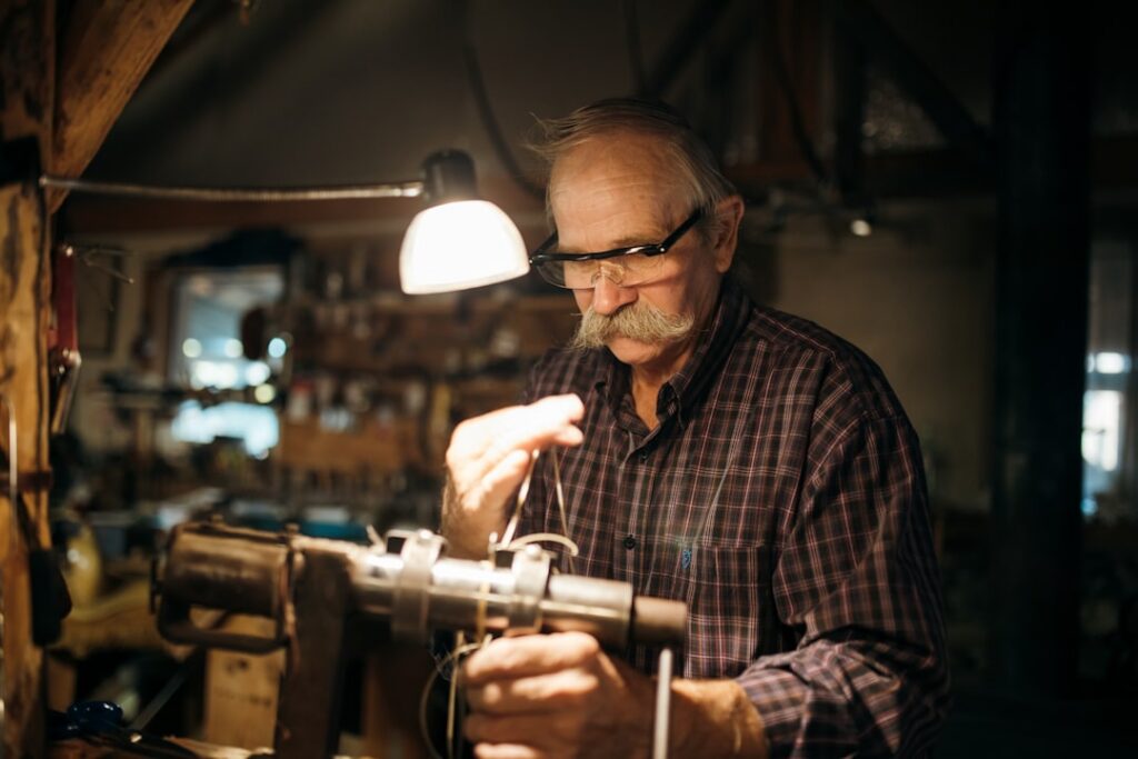 Small business owner smiling confidently in their print shop workshop