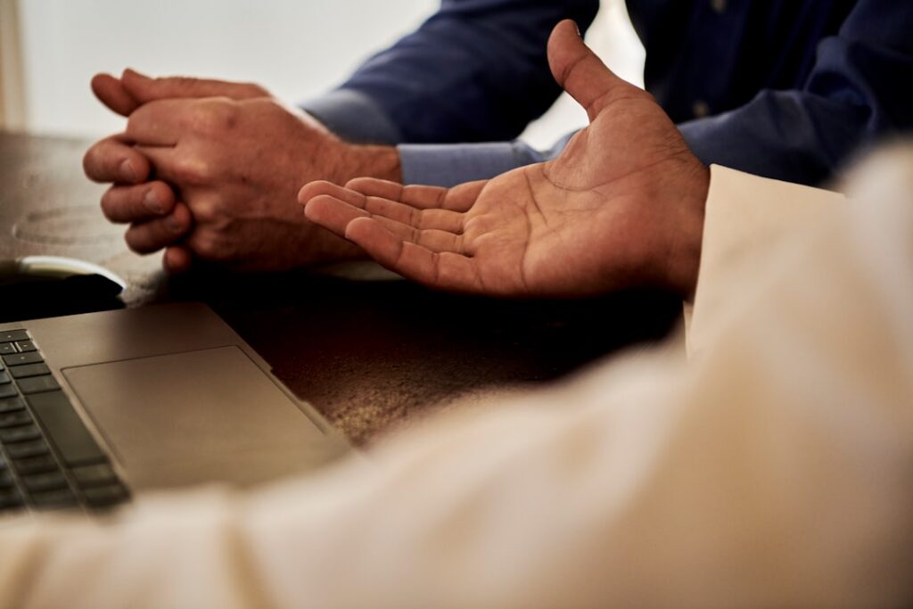 Handshake across a desk during a business debt settlement negotiation