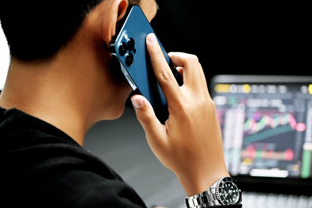 Freight broker on the phone coordinating a load at a dispatch desk