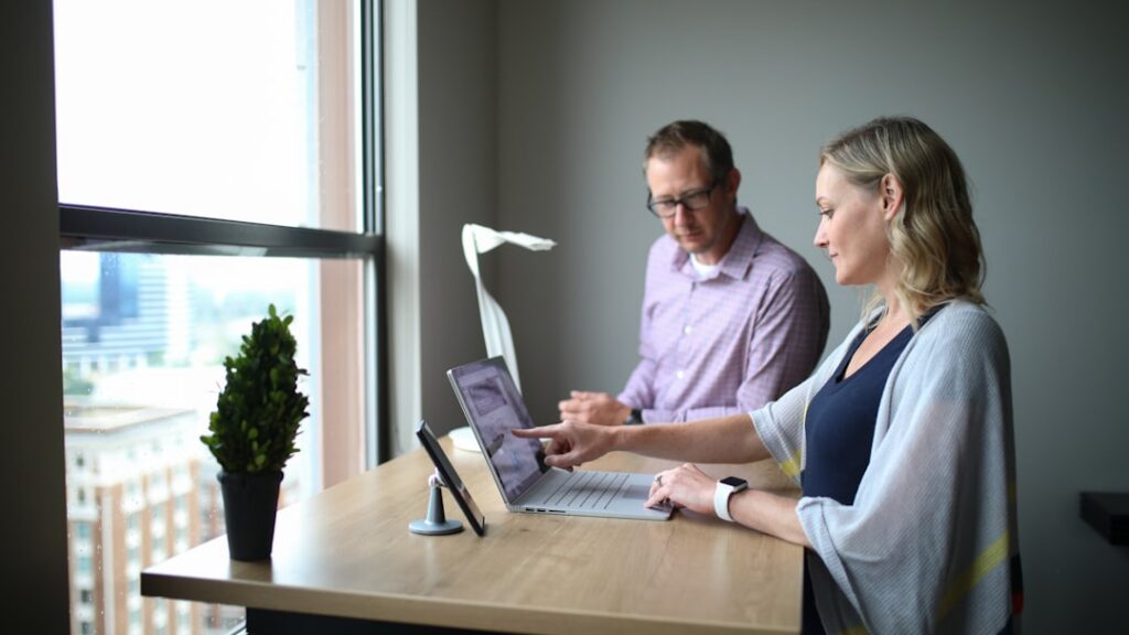 Business buyer and seller reviewing acquisition paperwork at a desk