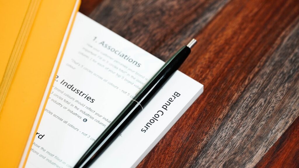 Stack of financing documents and a pen on an office desk
