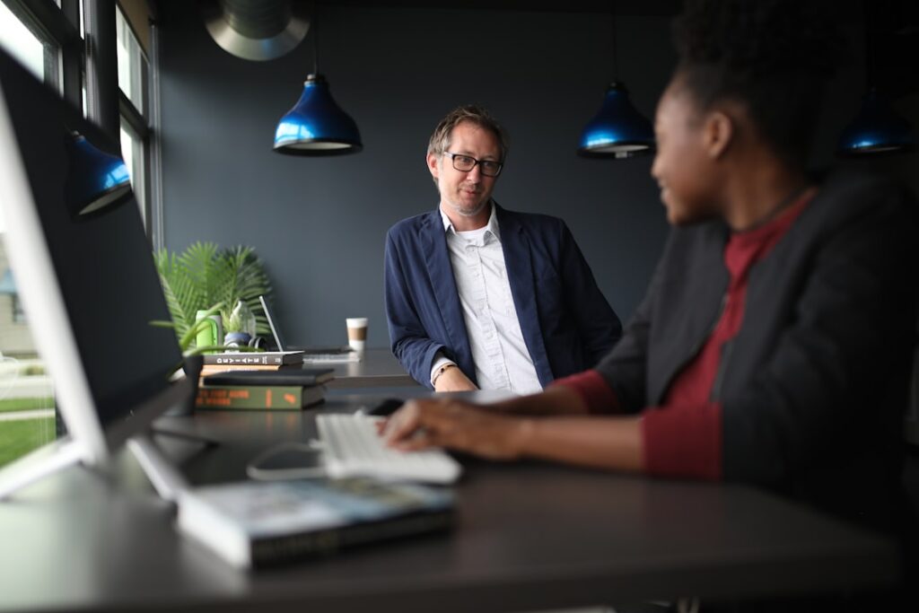 Buyer and seller shaking hands over a business acquisition contract
