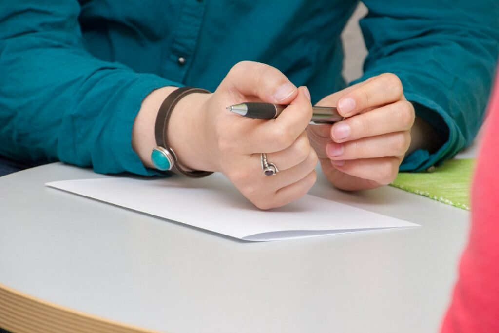 Small business owner reviewing financing contract terms with an advisor