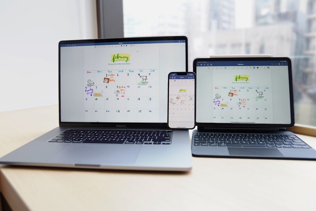 Wall calendar with September circled next to an open laptop on a desk