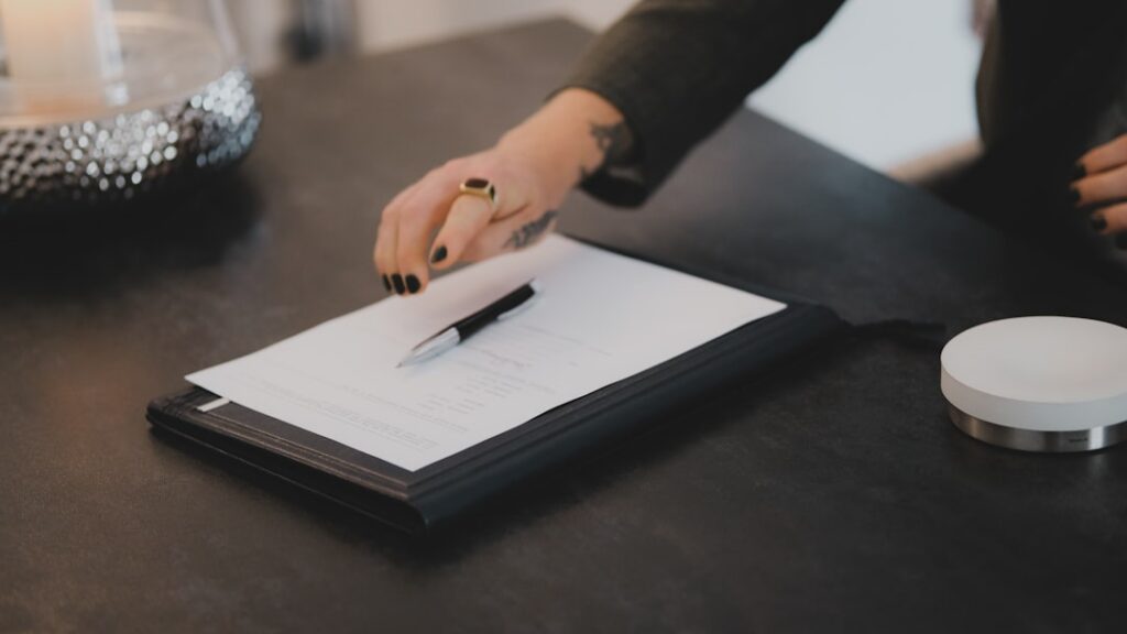 Business owner reviewing a financing contract at a small office desk