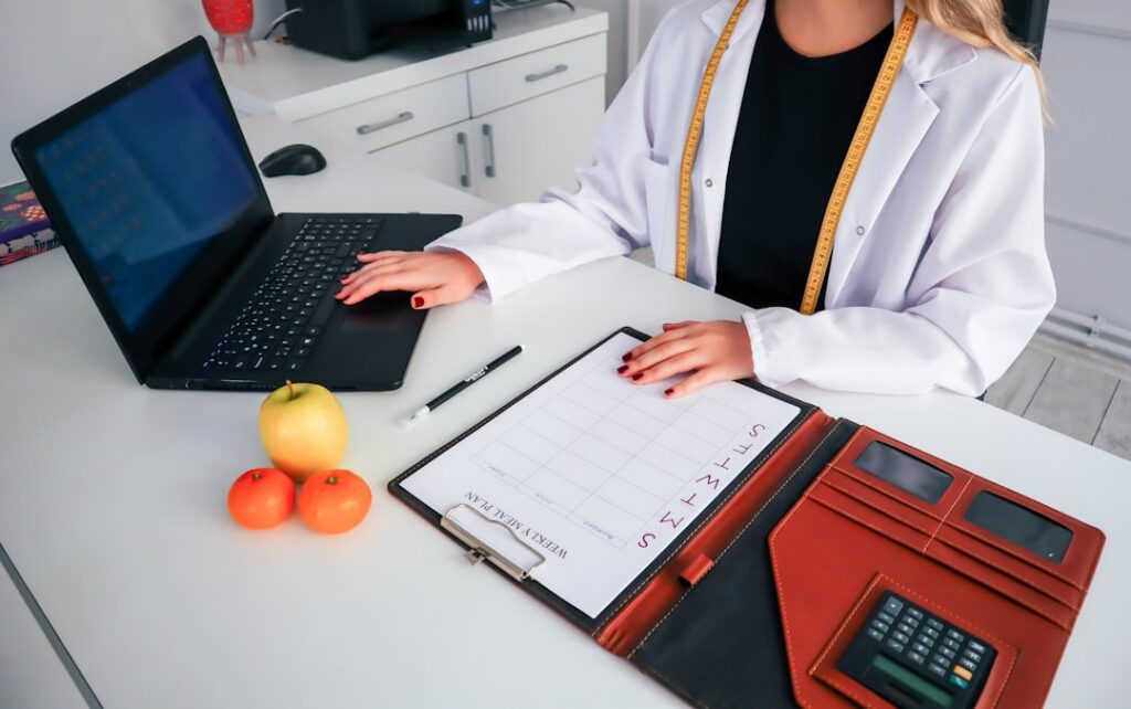 Dentist reviewing insurance claim paperwork and bills at a desk