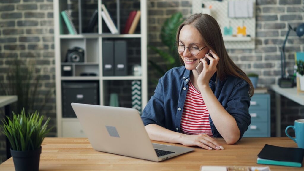 Business owner on a phone call feeling confident after finding a path forward