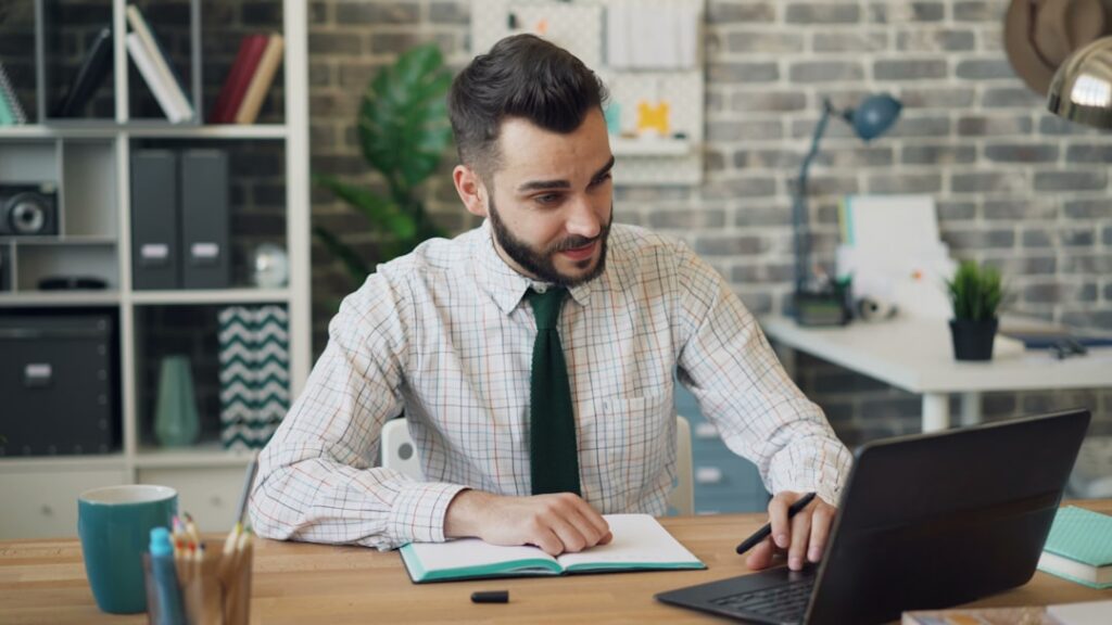 Business owner reading a past due rent notice at a small office desk