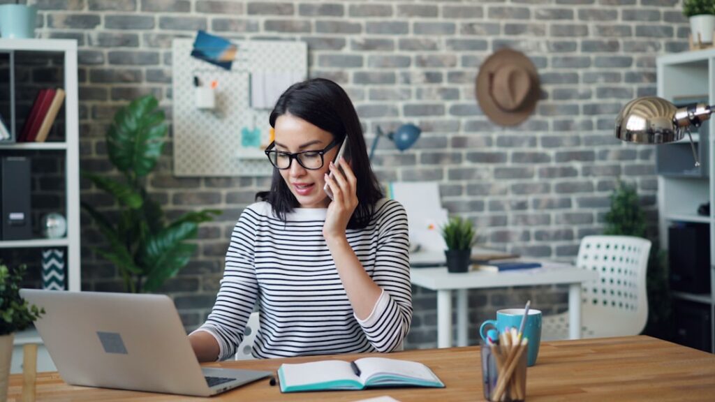 Business owner on a phone call negotiating terms at an office desk