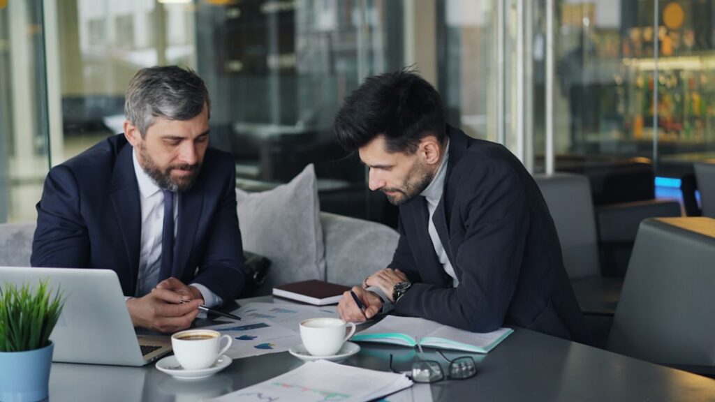 Business owner and advisor discussing a settlement strategy across a table