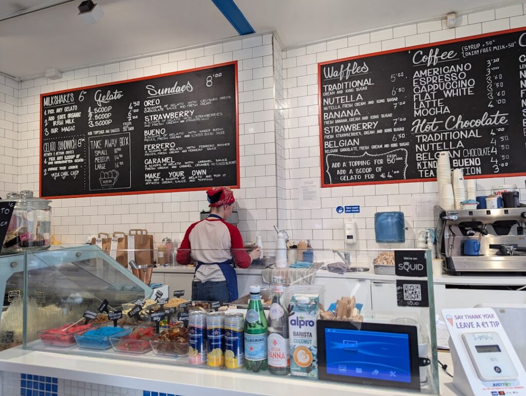 Small business owner at an ice cream shop counter reviewing receipts