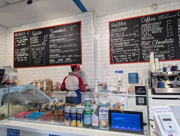 Small business owner at an ice cream shop counter reviewing receipts