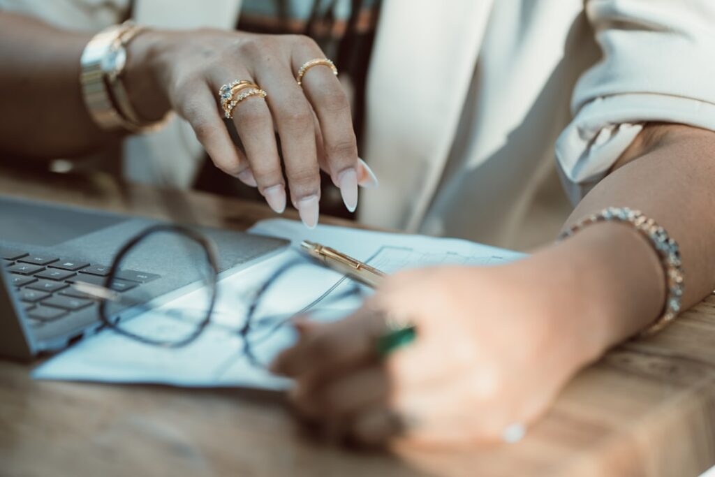 Close-up of a hand signing a business financing agreement