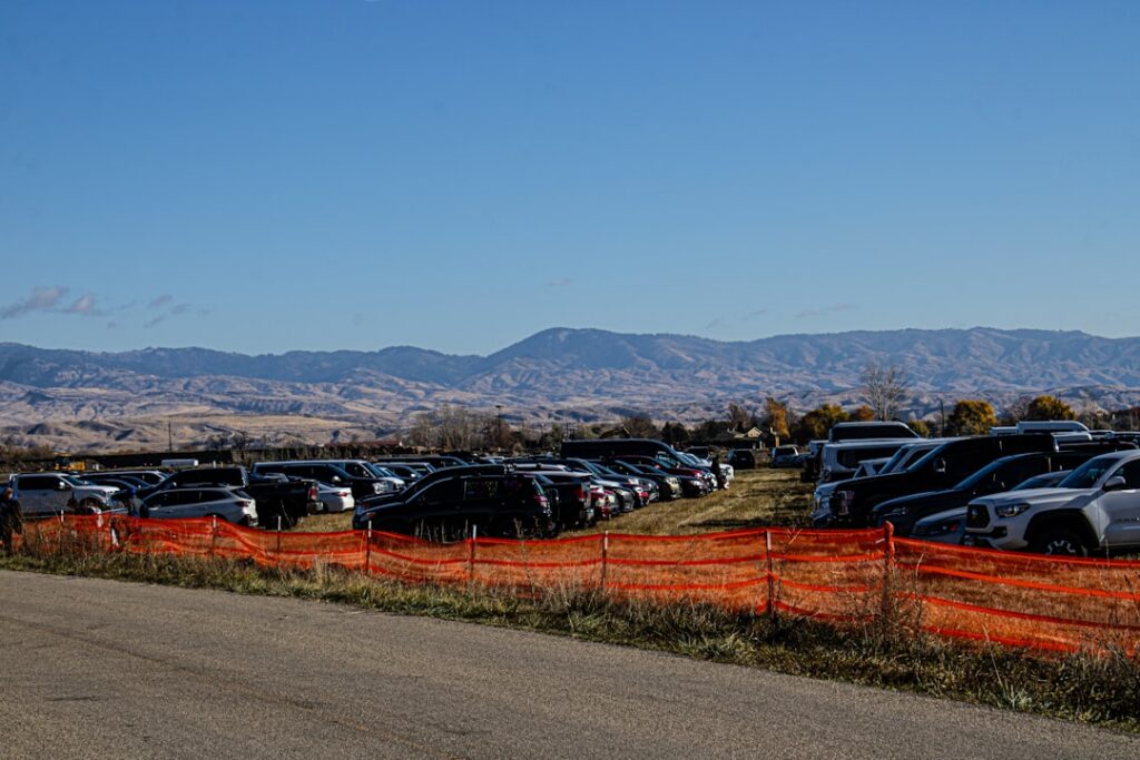 Municipal impound lot with towed vehicles parked behind a chain link fence