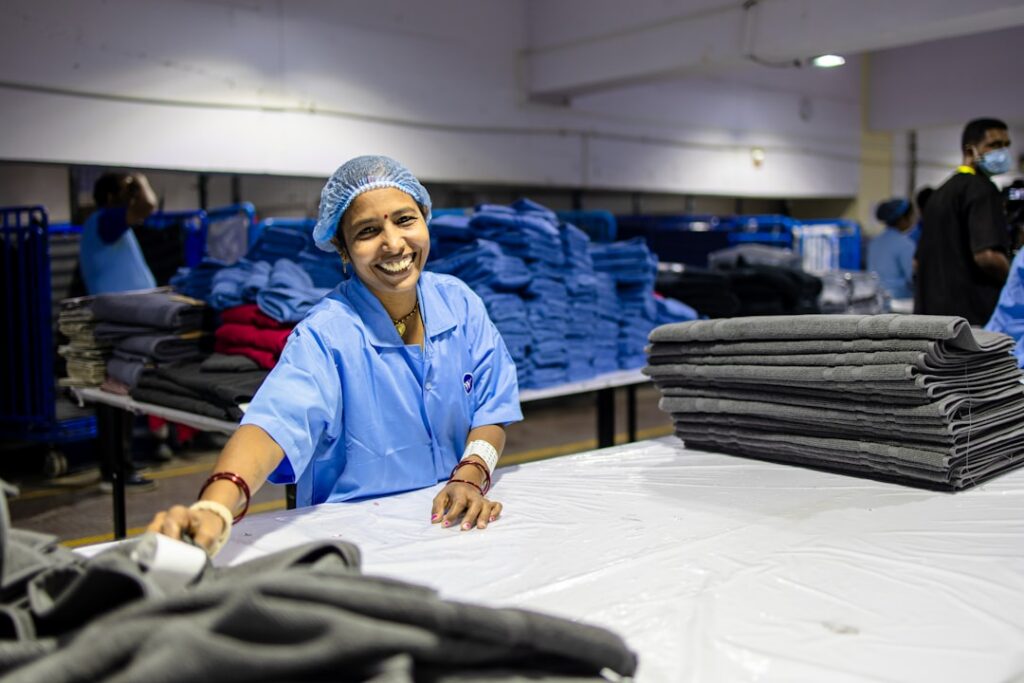 Warehouse worker packing apparel orders for e-commerce shipping