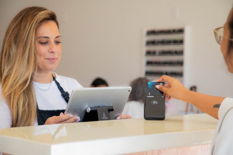 Small business owner reviewing a card processing statement showing multiple deductions