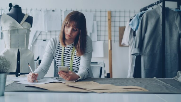 Business owner reading a legal notice at a desk in a small workshop