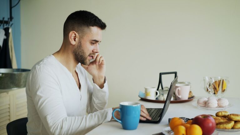 Small business owner reviewing a personal credit report at a laptop