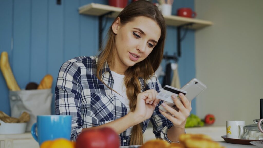 Small business owner reviewing several loan statements stacked on a table
