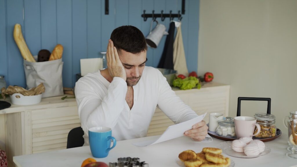 Small business owner reading an IRS notice at the kitchen table