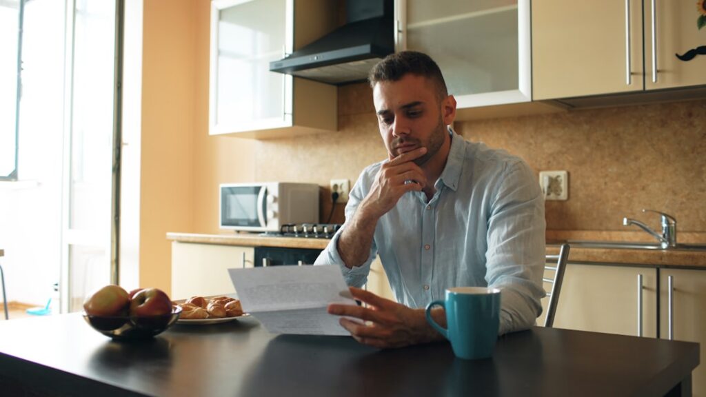 Business owner reviewing multiple advance statements at a table