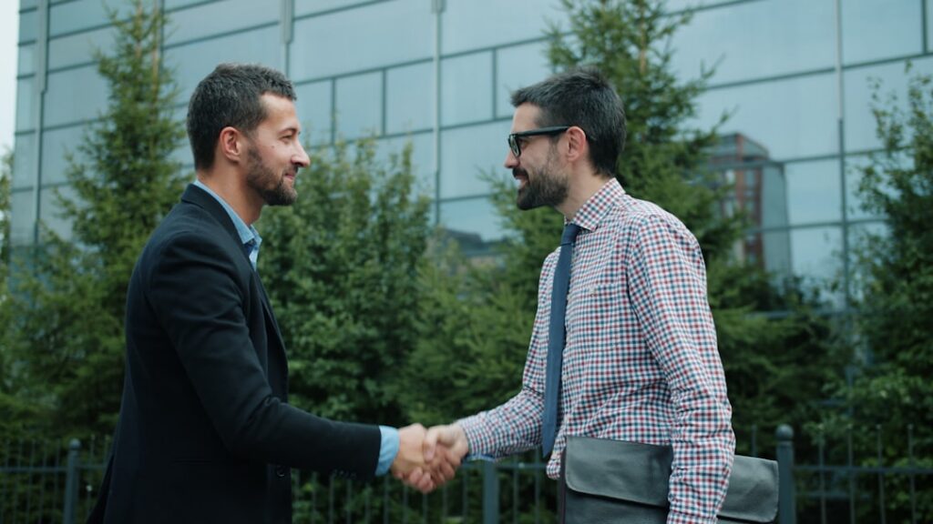 Business owner shaking hands after a negotiation meeting