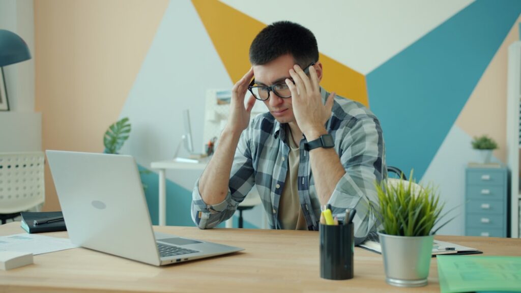 Small business owner reviewing multiple bills and bank statements