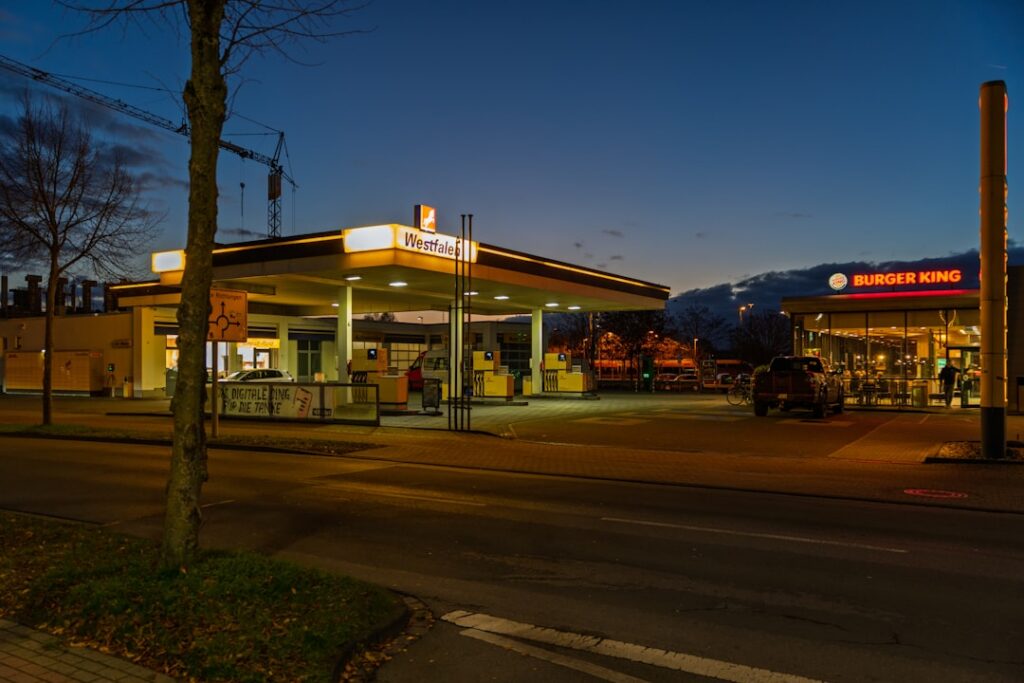 Gas station and convenience store with fuel pumps at dusk