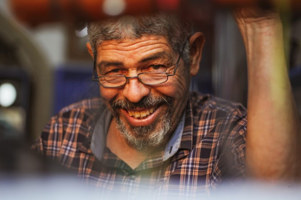 Relieved auto repair shop owner reviewing financial paperwork