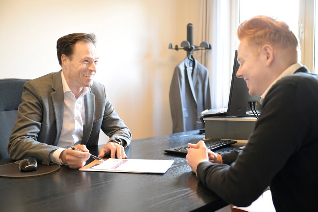 Business owner and specialist shaking hands after reaching a negotiated settlement