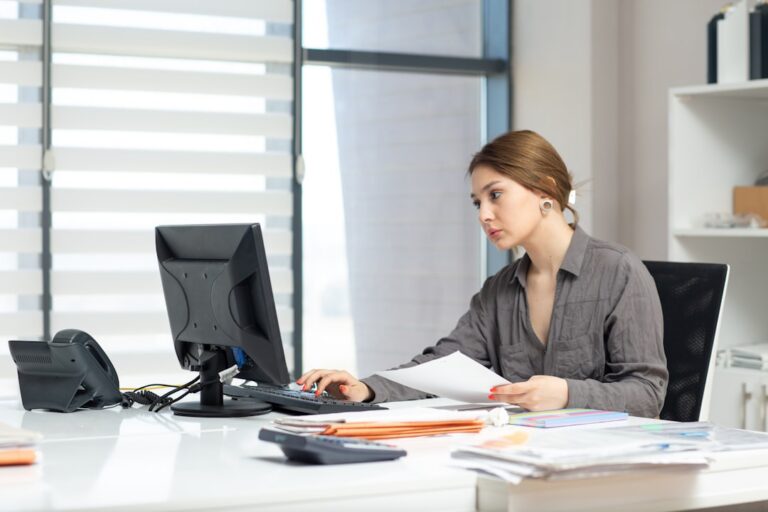 Business owner reviewing debt resolution paperwork at a desk