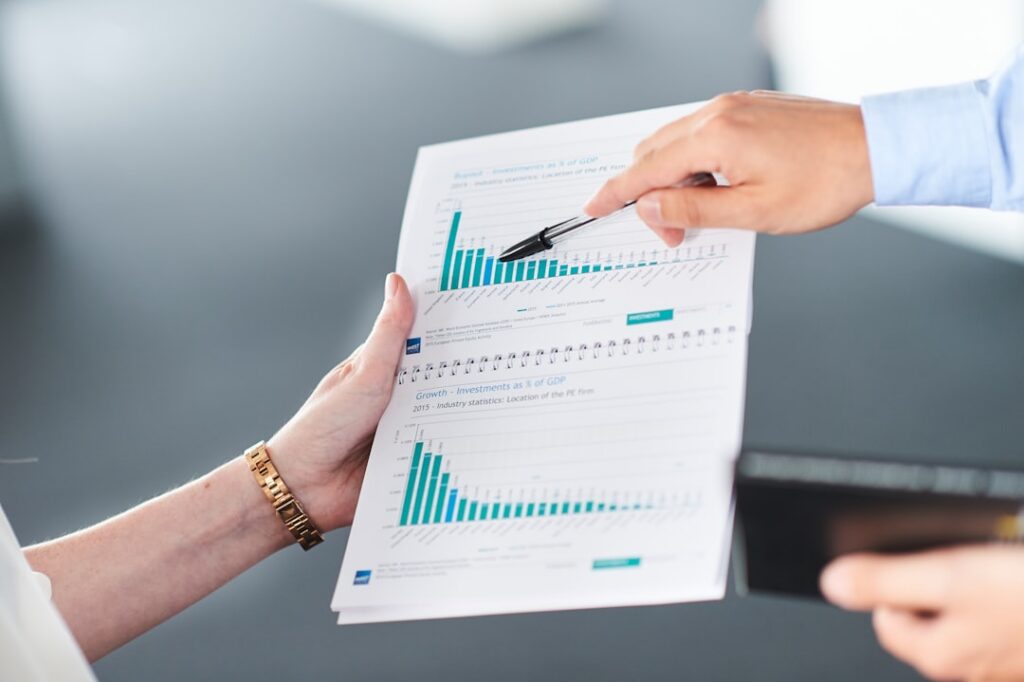 Handshake across a desk over financial settlement documents