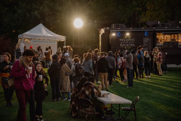 Food truck owner serving customers at an outdoor festival