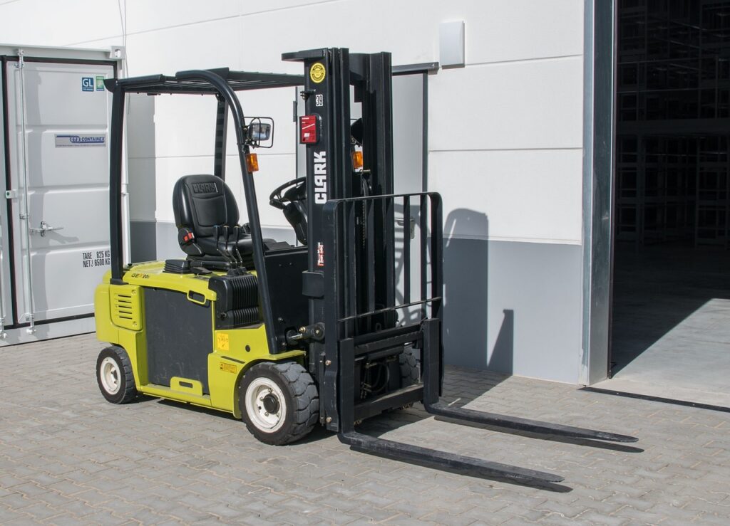 Forklift operator loading pallets in a wholesale distribution warehouse