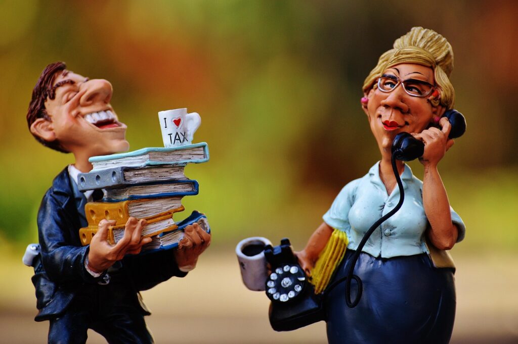 Business owner on the phone discussing debt relief options from a workshop office
