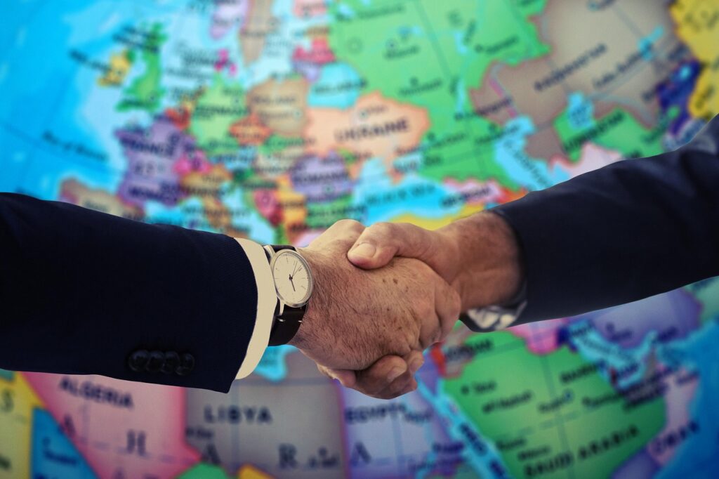 Business owner and advisor shaking hands after a settlement negotiation