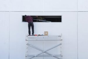 Electrical contractor reviewing paperwork and invoices beside a work van