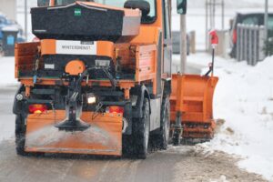Snow plow truck parked at a contractor's lot ahead of winter season