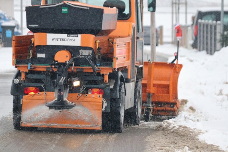 Snow plow truck parked at a contractor's lot ahead of winter season