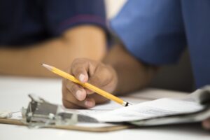 Funeral home director reviewing financial paperwork at an office desk