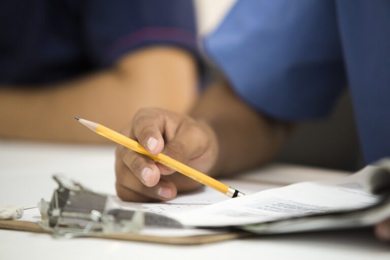 Funeral home director reviewing financial paperwork at an office desk