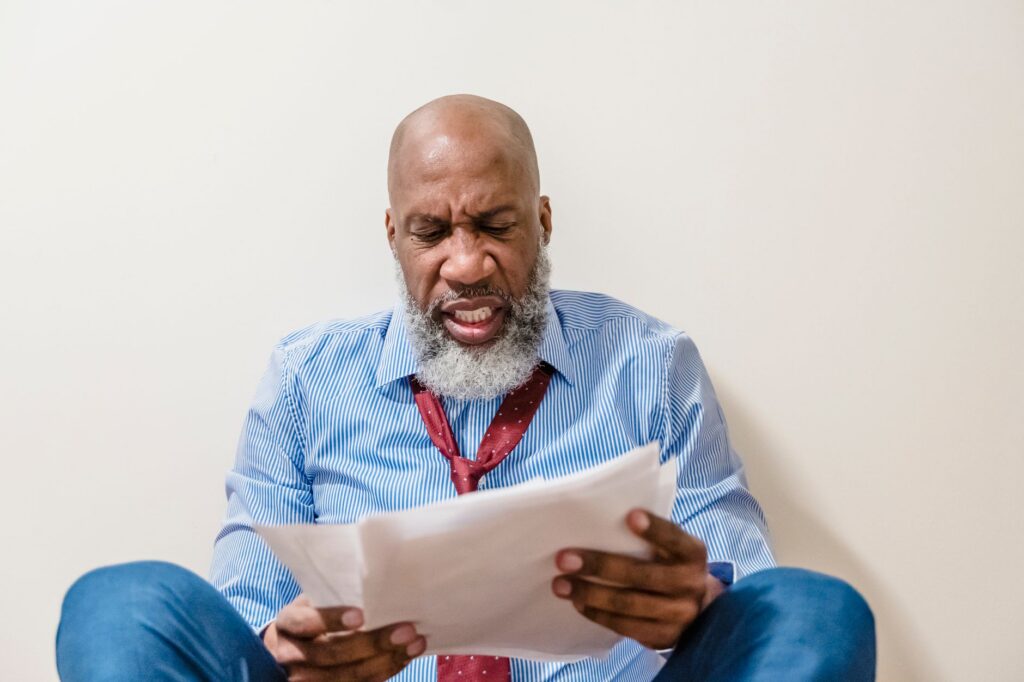 Business owner reading a default notice after a breach of contract